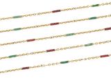 a close up of a row of gold chains with green and red beads