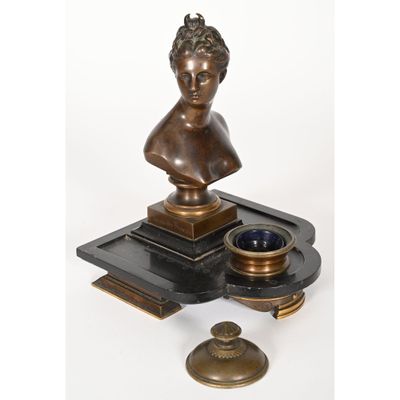 an image of a bronze bust of a woman on a tray