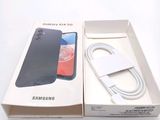 a box with a phone inside of it on a white surface