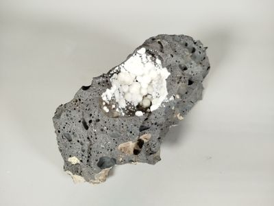 a piece of rock with a white substance on top of it