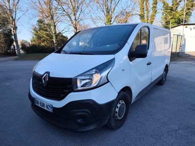 a white van parked in a parking lot with trees in the background