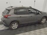 a grey car parked in a garage with a checkered floor
