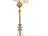 a gold floor lamp with a white shade on top of it
