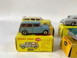 three toy cars sitting on top of boxes on a table