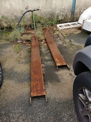 des voitures garées sur un parking à côté d'un immeuble dont une vitre est cassée