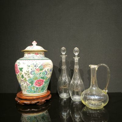 three vases and a pitcher sitting on a table