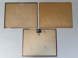 three pieces of wood are hanging on a wall in a room