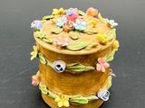 a small wooden box with flowers on it on a table