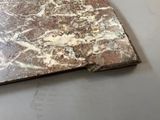 a piece of marble sitting on the floor next to a pair of scissors