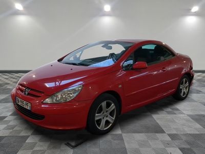 la voiture rouge est garée sur le sol en damier du garage