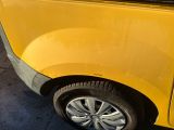 a yellow van that is parked on the side of the road