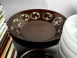 many plates and bowls sitting on a table