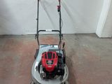 a small lawn mower sitting on the floor in a room