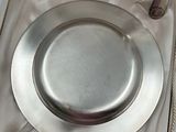 a silver plate in a box with a spoon in it