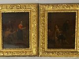 two paintings of a man and woman in gold frames on a wall