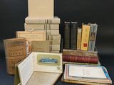 many books stacked on top of each other on a table