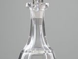 a glass decanter with a silver handle on a table