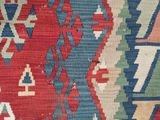 a close up of a red, blue, and green area rug