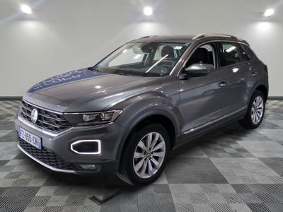 a grey volkswagen suv parked in a garage