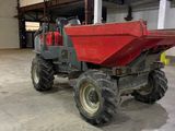 a red dump truck parked inside of a building