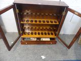 a wooden cabinet with a bunch of glasses inside of it