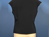 a black vest on a mannequin dummy with a blue background