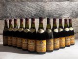 several bottles of wine are lined up in a row on a table