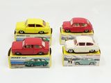 four toy cars are sitting in a box on a white surface
