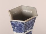 a blue and white vase with a dragon design on it