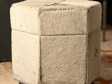a small ottoman sitting on a rug in a living room