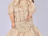 a doll that is wearing a dress and a bonnet
