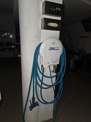 an electric charger attached to a pole in a room