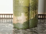 a glass with a picture of a forest on it