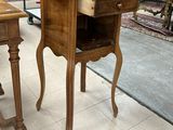 two wooden tables with drawers on them in a room