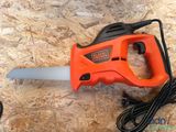 an orange and black electric saw sitting on top of a piece of wood
