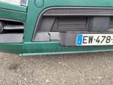 a close up of a green car with a license plate on it