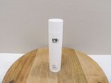 a white bottle sitting on top of a wooden table