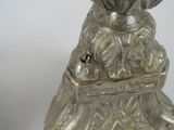 a silver candle that is sitting on top of a table