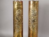 two gold vases sitting next to each other on a table