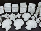 a lot of white figurines sitting on a table