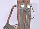 two binoculars that are sitting on a brown bag