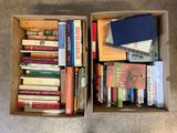 two boxes of books are sitting on the floor next to each other