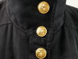 a close up of a black shirt with gold buttons on it