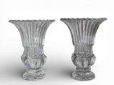 pair of clear glass vases on a white surface with a white background