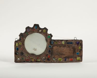 a small mirror sitting on top of a piece of wood