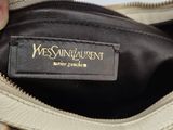someone is holding a purse with a label on it