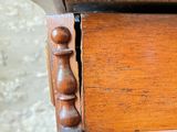 a close up of a wooden table with a drawer on it