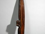 an image of a wooden sculpture of a person holding a knife