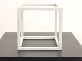 a white box on a black table with a white background