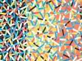 colorful sprinkles are scattered on a black surface with a black background